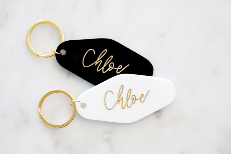 black or white custom motel keychain with gold lettering