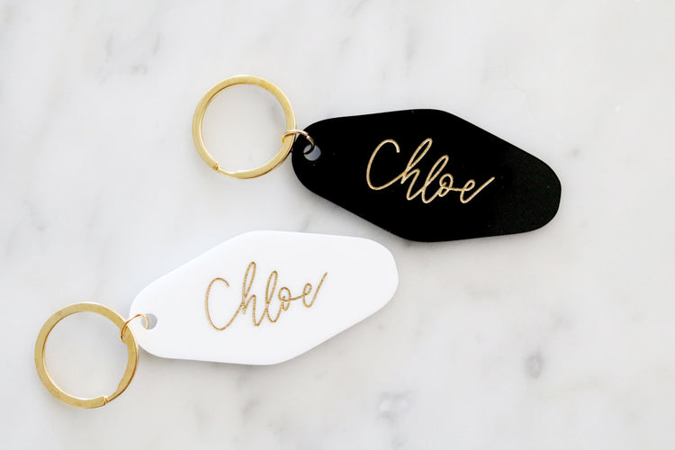 black or white custom motel keychain with gold lettering