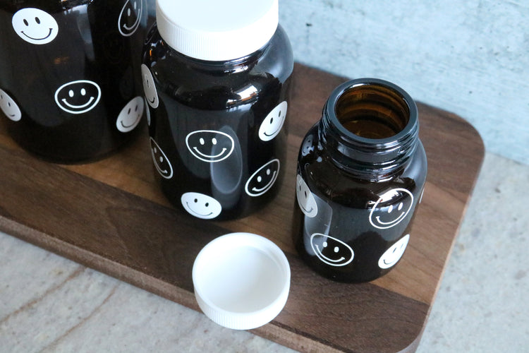 smiley face amber glass pill bottle | stash jar