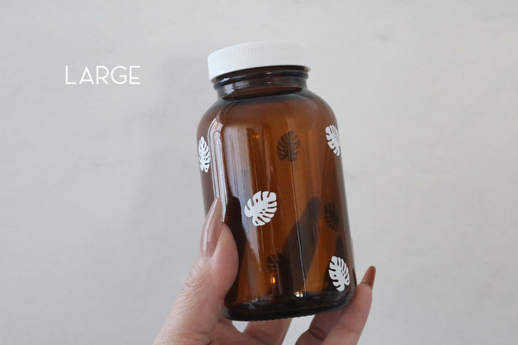 monstera leaf amber glass pill bottle